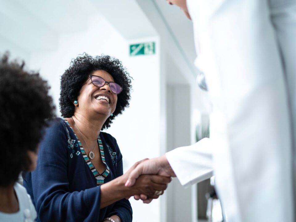 A doctor and patient's mother shaking hands