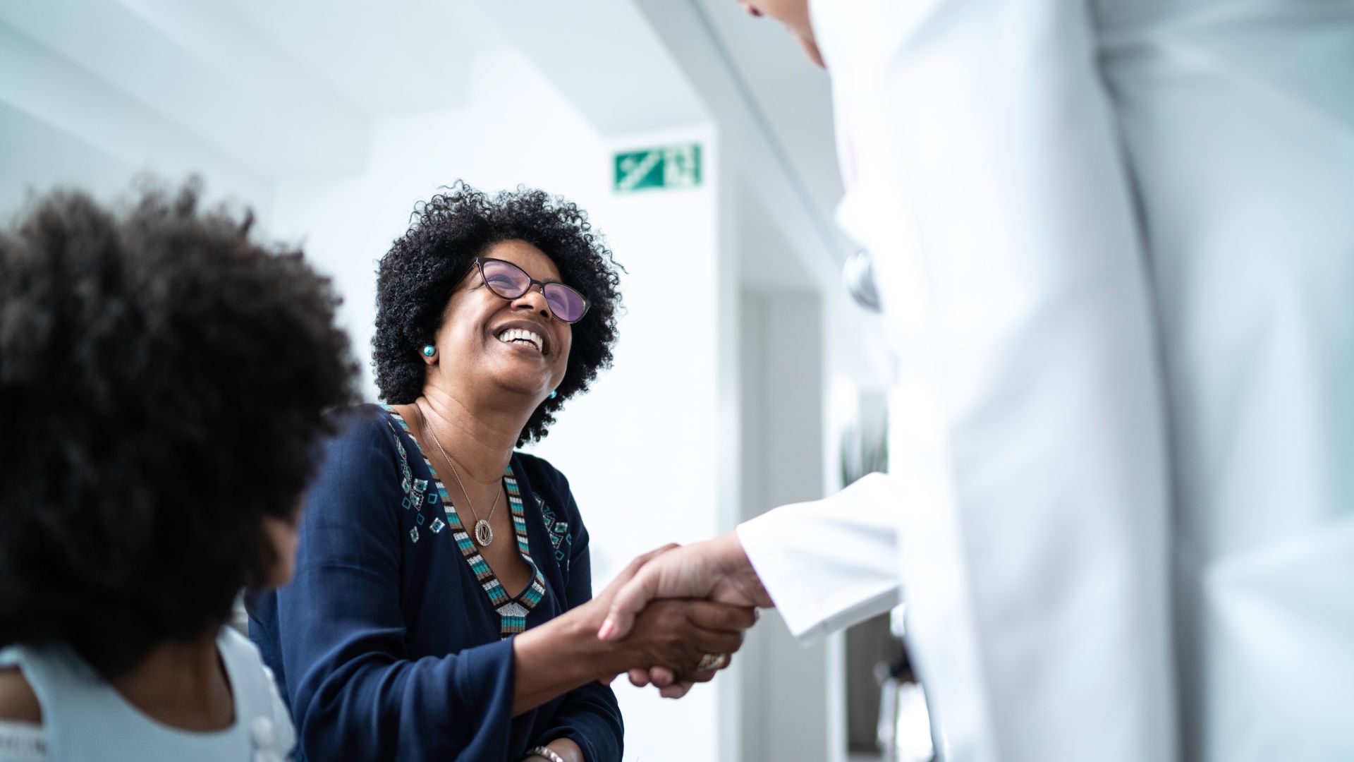 A doctor and patient's mother shaking hands