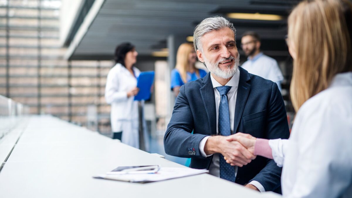 Doctor shaking hands with auditor