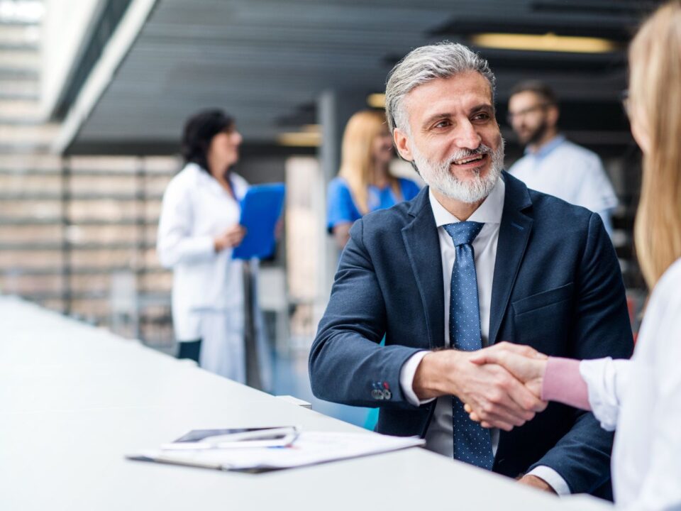 Doctor shaking hands with auditor